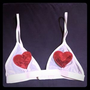 Nude bralette with red hearts.